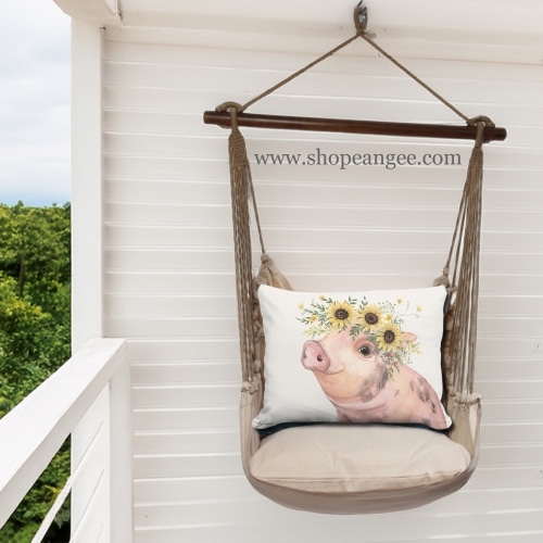 In a poolside chaise a multi colored outdoor swing crafted by the artisans of Magnolia Casual called the Swing Set 4 piece Latte Solid w/ Pig with Sunflowers is displayed featuring 100 percent weather resistant fabric, weather resistant polyester fabric, handcrafted adding comfort and style to the space.