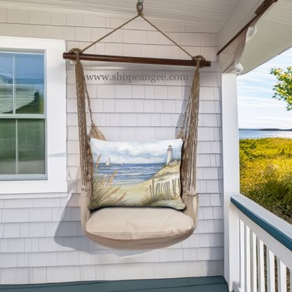 In a sunlit patio lounge a multi colored outdoor swing crafted by the artisans of Magnolia Casual called the Swing Set 4 piece Latte Solid w/ Beach and Lighthouse is displayed featuring 100 percent weather resistant fabric, weather resistant polyester fabric, handcrafted adding comfort and style to the space.