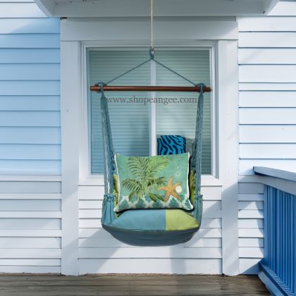 In a cozy garden seating area a multi colored outdoor swing crafted by the artisans of Magnolia Casual called the Swing Set 4 piece Meadow Mist Stripe w/ Starfish and Palm is displayed featuring 100 percent weather resistant fabric, weather resistant polyester fabric, handcrafted, natural materials adding comfort and style to the space featuring with a stripe motif.