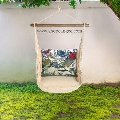 In a cozy garden seating area a multi colored outdoor swing crafted by the artisans of Magnolia Casual called the Swing Set 4 piece Magnolia Stripe w/ Botanical Mushrooms 2 is displayed featuring 100 percent weather resistant fabric, weather resistant polyester fabric, handcrafted adding comfort and style to the space featuring with a magnolia motif.