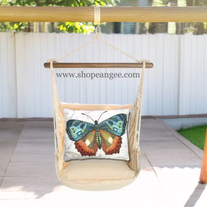In a cozy garden seating area a multi colored outdoor swing crafted by the artisans of Magnolia Casual called the Swing Set 4 piece Magnolia Stripe w/ Butterfly M2 is displayed featuring 100 percent weather resistant fabric, weather resistant polyester fabric, handcrafted adding comfort and style to the space featuring with a magnolia motif.