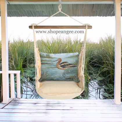 In a poolside chaise a multi colored outdoor swing crafted by the artisans of Magnolia Casual called the Swing Set 4 piece Magnolia Stripe w/ Avocet Bird in Water is displayed featuring 100 percent weather resistant fabric, weather resistant polyester fabric, handcrafted adding comfort and style to the space featuring with a magnolia motif.