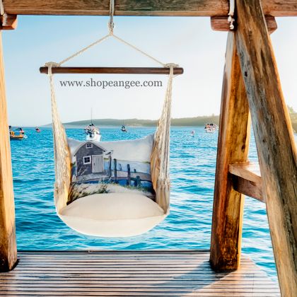 In a poolside chaise a multi colored outdoor swing crafted by the artisans of Magnolia Casual called the Swing Set 4 piece Magnolia Stripe w/ Boat House Pier is displayed featuring 100 percent weather resistant fabric, weather resistant polyester fabric, handcrafted adding comfort and style to the space featuring with a magnolia motif.