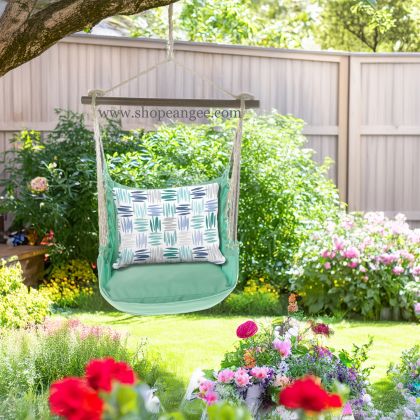 In a poolside chaise a green outdoor swing crafted by the artisans of Magnolia Casual called the Swing Set 4 piece Seafoam Green Solid w/ Whimsy Strokes is displayed featuring 100 percent weather resistant fabric, weather resistant polyester fabric, handcrafted adding comfort and style to the space featuring shades of green.