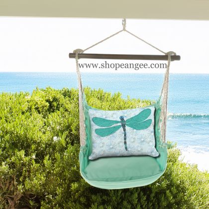 In an outdoor reading nook a green outdoor swing crafted by the artisans of Magnolia Casual called the Swing Set 4 piece Seafoam Green Solid w/ Dragonfly with Lilly Pads is displayed featuring 100 percent weather resistant fabric, weather resistant polyester fabric, handcrafted adding comfort and style to the space featuring with a dragonfly motif and shades of green.