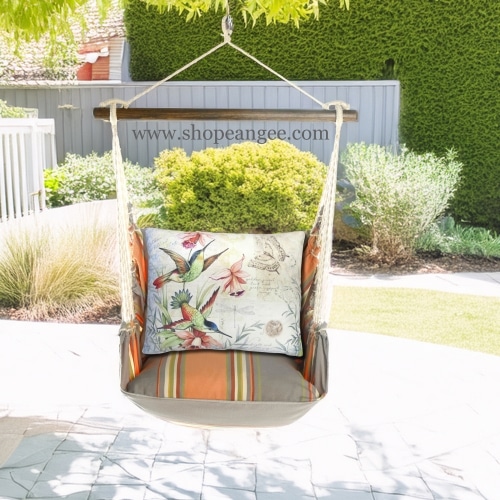 In a poolside chaise a multi colored outdoor swing crafted by the artisans of Magnolia Casual called the Swing Set 4 piece Serene Sunset w/ Hummingbirds is displayed featuring 100 percent weather resistant fabric, weather resistant polyester fabric, handcrafted adding comfort and style to the space.