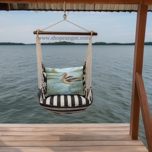 In a cozy garden seating area a black outdoor swing crafted by the artisans of Magnolia Casual called the Swing Set 4 piece True Black Stripe w/ Avocet Bird in Water is displayed featuring 100 percent weather resistant fabric, weather resistant polyester fabric, handcrafted adding comfort and style to the space featuring with a stripe motif and shades of black.