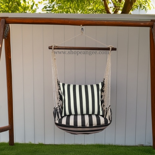 In a shaded porch swing a black outdoor swing crafted by the artisans of Magnolia Casual called the Swing Set 4 piece True Black Stripe w/ True Black Stripe is displayed featuring 100 percent weather resistant fabric, weather resistant polyester fabric, handcrafted adding comfort and style to the space featuring with a stripe motif and shades of black.