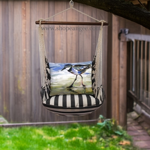 In an outdoor reading nook a black outdoor swing crafted by the artisans of Magnolia Casual called the Swing Set 4 piece True Black Stripe w/ Sandpiper is displayed featuring 100 percent weather resistant fabric, weather resistant polyester fabric, handcrafted adding comfort and style to the space featuring with a stripe motif and shades of black.