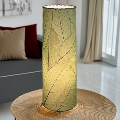 Slim cylinder table lamp crafted by Eangee Home Design in green fossilized cocoa leaves, each panel hand?laminated and stitched; minimalist form offers textural leaf detail while ambient light spills across the textured leaf panels; artisan?made with renewable materials