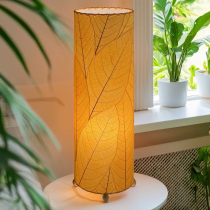 Slim cylinder table lamp crafted by Eangee Home Design in orange fossilized cocoa leaves, each panel hand?laminated and stitched; minimalist form offers textural leaf detail while gentle light radiates across the textured leaf panels; handcrafted sustainably by fair?trade artisans