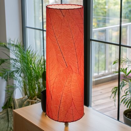 Slim cylinder table lamp crafted by Eangee Home Design in red fossilized cocoa leaves, each panel hand?laminated and stitched; minimalist form offers textural leaf detail while soothing light filters through translucent cocoa leaves; sustainably handcrafted by skilled artisans
