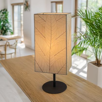Tall Sequoia?inspired table lamp crafted by Eangee Home Design clad in natural fossilized cocoa leaves on a curved wrought?iron frame; towering form echoes tree bark texture, and soothing light spills through organic leaf texture; artisan?made with renewable materials