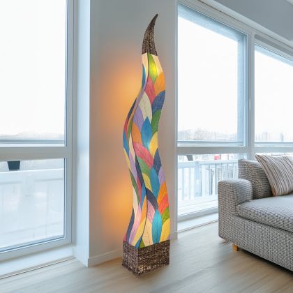 In a studio setting, the Flame Giant crafted by the artisans of Eangee Home Design Lamp in multi color finish by Eangee Home Design creates an inviting atmosphere with its fossilized cocoa leaf panels, abaca twine accents, and hand placed natural leaves.