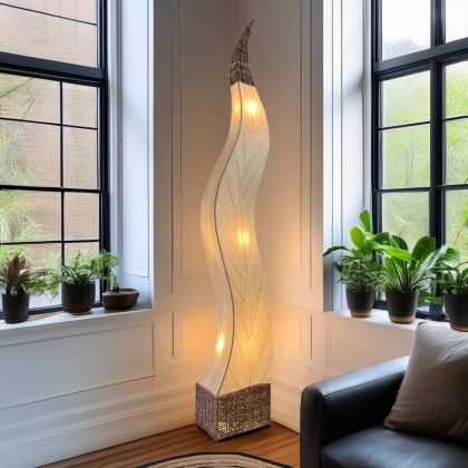 In a studio setting, the Flame Giant crafted by the artisans of Eangee Home Design Lamp in natural finish by Eangee Home Design creates an inviting atmosphere with its fossilized cocoa leaf panels, abaca twine accents, and hand placed natural leaves.