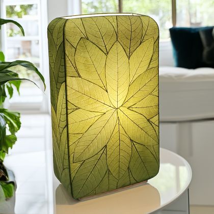 Crafted by the artisans of Eangee Home Design, the Sunburst Giant Floor Lamp in green against a clean backdrop, featuring fossilized cocoa leaf shade, fair trade, handcrafted.