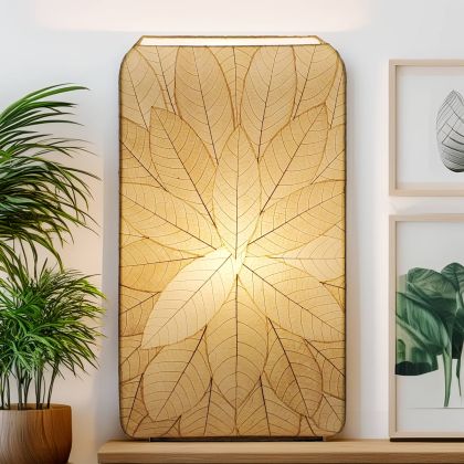 Sunburst?pattern table lamp crafted by Eangee Home Design featuring radial natural fossilized leaf panels over wrought iron; sculptural burst design comes to life as glowing light filters through translucent cocoa leaves; handcrafted sustainably by fair?trade artisans