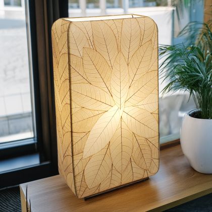 Crafted by the artisans of Eangee Home Design, the Sunburst Giant Floor Lamp in natural against a clean backdrop, featuring fossilized cocoa leaf shade, fair trade, handcrafted.