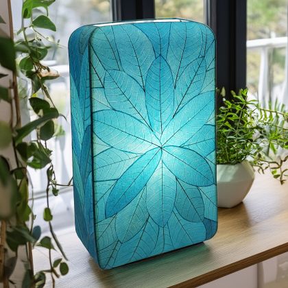 Crafted by the artisans of Eangee Home Design, the Sunburst Giant Floor Lamp in sea blue against a clean backdrop, featuring fossilized cocoa leaf shade, fair trade, handcrafted.