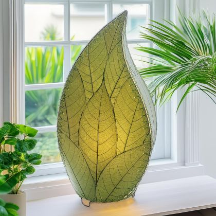 Leaf?shaped Leaflet table lamp crafted by Eangee Home Design with green fossilized cocoa leaves stitched by hand to wrought iron; budding?leaf form breathes life as cozy light glows through the natural leaf veins; fair?trade craftsmanship using sustainable resources