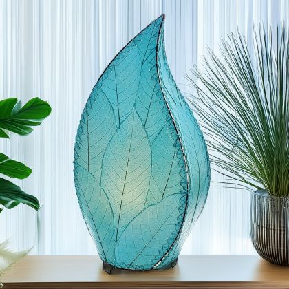In a quiet bedside corner, crafted by the artisans of Eangee Home Design, the 24 Inch Leaflet Lamp in sea blue stands gracefully, featuring fossilized cocoa leaf shade, abaca rope accents, wrought iron frame, handcrafted, adding warmth and character to the space.