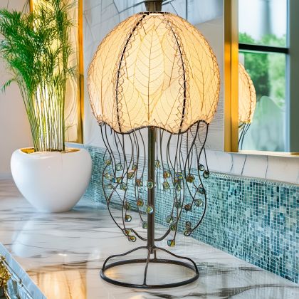 In a minimalist loft with natural textures, crafted by the artisans of Eangee Home Design, the Jellyfish Table Lamp in natural stands gracefully, featuring fossilized cocoa leaf shade, abaca rope accents, wrought iron frame, handcrafted, adding warmth and character to the space.