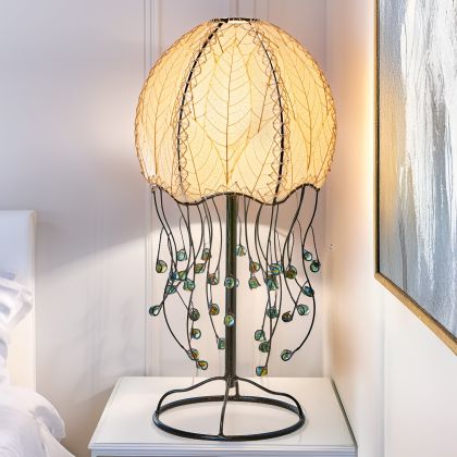 Jellyfish?inspired table lamp crafted by Eangee Home Design draped in natural cocoa?leaf panels that flow like tentacles; underwater feel enhanced as radiant light radiates through the natural leaf veins; handcrafted sustainably by fair?trade artisans