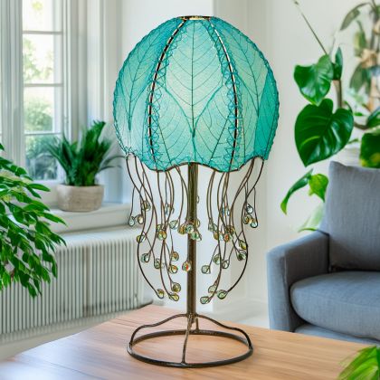 Crafted by the artisans of Eangee Home Design, the Jellyfish Table Lamp in sea blue against a clean backdrop, featuring fossilized cocoa leaf shade, abaca rope accents, wrought iron frame, handcrafted.
