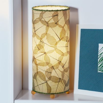 In a coastal inspired living room, crafted by the artisans of Eangee Home Design, the Banyan Table Lamp in green stands gracefully, featuring wrought iron frame, eco friendly, adding warmth and character to the space.