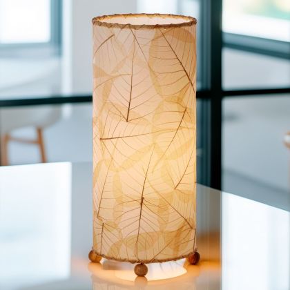 Banyan?inspired table lamp crafted by Eangee Home Design woven with natural fossilized cocoa leaves between wrought?iron ribs; branching silhouette highlights leaf texture while ambient light spills through the natural leaf veins; fair?trade craftsmanship using sustainable resources