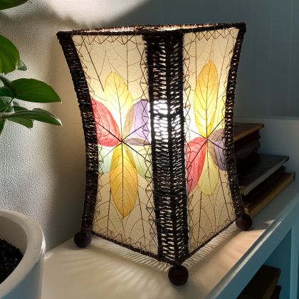 Hourglass?shaped table lamp crafted by Eangee Home Design sculpted from multi color fossilized jackfruit leaves, abaca accents; graceful curve glows as ambient light shines across the textured leaf panels; handcrafted sustainably by fair?trade artisans