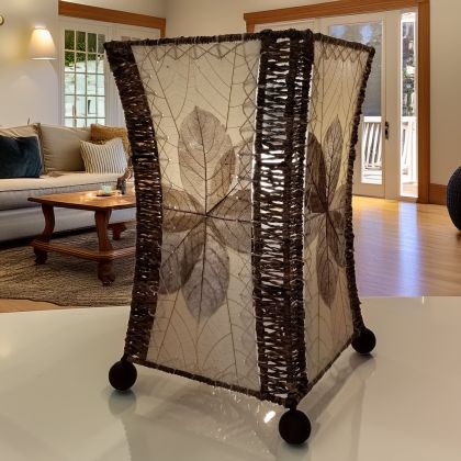 Hourglass?shaped table lamp crafted by Eangee Home Design sculpted from natural fossilized jackfruit leaves, abaca accents; graceful curve glows as cozy light shines through every vein; artisan?made with renewable materials