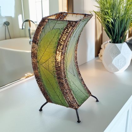 Sculptural table lamp crafted by Eangee Home Design fashioned from green natural leaves; organic texture revealed as glowing light glows through translucent cocoa leaves; eco?friendly, artisan?crafted design