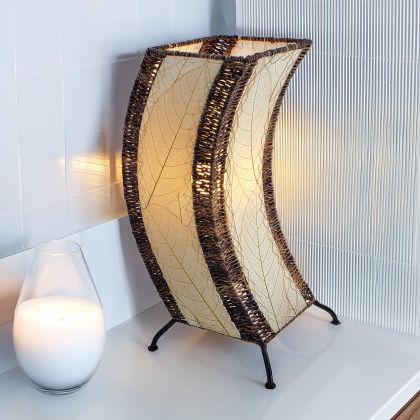 Sculptural table lamp crafted by Eangee Home Design fashioned from natural natural leaves; organic texture revealed as cozy light shines through translucent cocoa leaves; artisan?made from sustainable materials