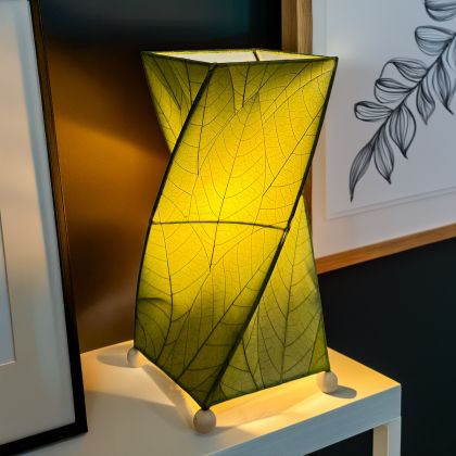 Twisted cube table lamp crafted by Eangee Home Design clad in vertical green fossilized cocoa leaves; 90?degree rotation adds dynamism while soft light radiates against the leaf?veined surface; eco?friendly, artisan?crafted design
