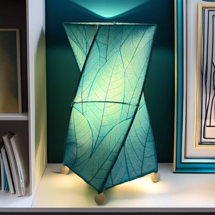Twisted cube table lamp crafted by Eangee Home Design clad in vertical sea blue fossilized cocoa leaves; 90?degree rotation adds dynamism while gentle light radiates against the leaf?veined surface; artisan?made with renewable materials