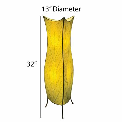 In a reading nook with a linen armchair, the Flowerbud Large Floor crafted by the artisans of Eangee Home Design Lamp in green finish by Eangee Home Design stands tall, its fossilized cocoa leaf panels and hand placed natural leaves casting a warm glow that the flower bud large floor lamp draws you in before it even lights up.