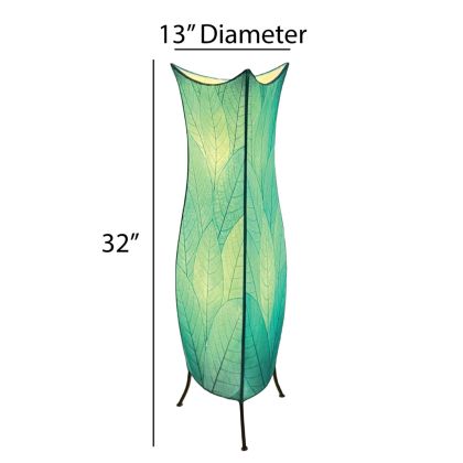 In a modern living room, the Flowerbud Large Floor crafted by the artisans of Eangee Home Design Lamp in sea blue finish by Eangee Home Design stands tall, its fossilized cocoa leaf panels and hand placed natural leaves casting a warm glow that the flower bud large floor lamp draws you in before it even lights up.