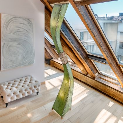 In a sun drenched entryway, crafted by the artisans of Eangee Home Design, the Flow Giant Floor Lamp in green stands gracefully, featuring fossilized cocoa leaf shade, abaca rope accents, eco friendly, adding warmth and character to the space.