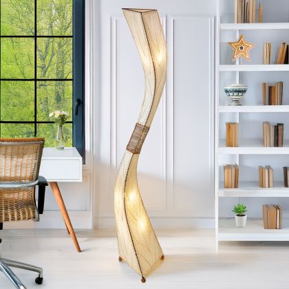 In a minimalist den with wooden accents, the Flow Giant Floor crafted by the artisans of Eangee Home Design Lamp in natural finish by Eangee Home Design stands tall, its fossilized cocoa leaf panels, abaca twine accents, and hand placed natural leaves casting a warm glow that there's a moment just before the wind shifts or a dancer turns where motion becomes emotion.