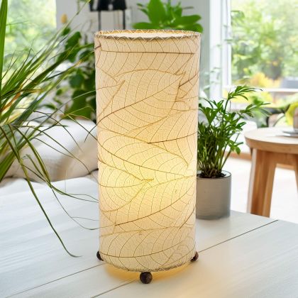 Slim cylinder table lamp crafted by Eangee Home Design in natural fossilized cocoa leaves, each panel hand?laminated and stitched; minimalist form offers textural leaf detail while gentle light pours through the natural leaf veins; artisan?made with renewable materials