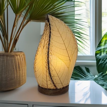 Crafted by the artisans of Eangee Home Design, the Leaflet Table Lamp in natural against a clean backdrop, featuring fossilized cocoa leaf shade, abaca rope accents, reclaimed mango wood base, wrought iron frame, sustainably sourced.