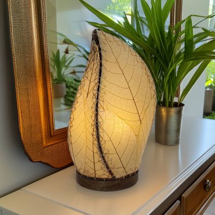 Leaf?shaped Leaflet table lamp crafted by Eangee Home Design with natural fossilized cocoa leaves stitched by hand to wrought iron; budding?leaf form breathes life as ambient light shines against the leaf?veined surface; artisan?made from sustainable materials