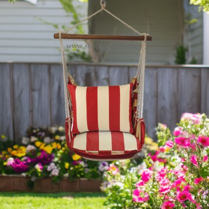 In a shaded porch swing a multi colored outdoor swing crafted by the artisans of Magnolia Casual called the Swing Set 4 piece Americana Stripe w/ Americana Stripe is displayed featuring 100 percent weather resistant fabric, weather resistant polyester fabric, handcrafted adding comfort and style to the space featuring with a stripe motif.