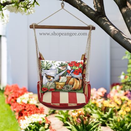 In a sunlit patio lounge a multi colored outdoor swing crafted by the artisans of Magnolia Casual called the Swing Set 4 piece Americana Stripe w/ Watering Can and Flower Pots is displayed featuring 100 percent weather resistant fabric, weather resistant polyester fabric, handcrafted adding comfort and style to the space featuring with a stripe motif.