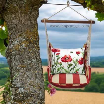 In a cozy garden seating area a multi colored outdoor swing crafted by the artisans of Magnolia Casual called the Swing Set 4 piece Americana Stripe w/ Poppies & Bee is displayed featuring 100 percent weather resistant fabric, weather resistant polyester fabric, handcrafted adding comfort and style to the space featuring with a stripe motif.