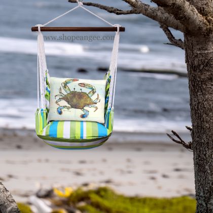 In a sunlit patio lounge a multi colored outdoor swing crafted by the artisans of Magnolia Casual called the Swing Set 4 piece Beach Boulevard Stripe w/ Traditional Crab is displayed featuring 100 percent weather resistant fabric, weather resistant polyester fabric adding comfort and style to the space featuring with a stripe motif.