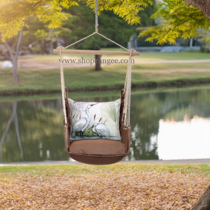 In a poolside chaise a multi colored outdoor swing crafted by the artisans of Magnolia Casual called the Swing Set 4 piece Chocolate Solid w/ Heron Pair is displayed featuring 100 percent weather resistant fabric, weather resistant polyester fabric, artisan, natural materials adding comfort and style to the space.