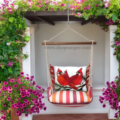 In a shaded porch swing a multi colored outdoor swing crafted by the artisans of Magnolia Casual called the Swing Set 4 piece Cristina Stripe w/ Cardinal Pair is displayed featuring 100 percent weather resistant fabric, weather resistant polyester fabric, handcrafted adding comfort and style to the space featuring with a stripe motif.