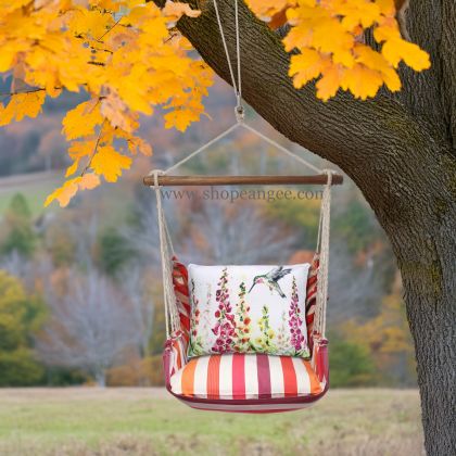 In a sunlit patio lounge a multi colored outdoor swing crafted by the artisans of Magnolia Casual called the Swing Set 4 piece Cristina Stripe w/ Foxgloves w/Hummingbird is displayed featuring 100 percent weather resistant fabric, weather resistant polyester fabric, handcrafted adding comfort and style to the space featuring with a stripe motif.